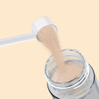 Qallo Energy Tropical Fruits tub: scoop of powder poured into a bottle