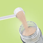 Qallo Energy Watermelon tub: scoop of powder poured into a bottle