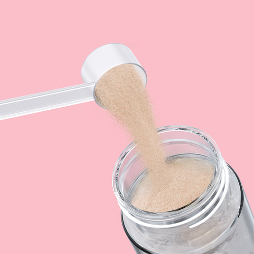 Qallo Energy Wild Berries tub: scoop of powder poured into a bottle