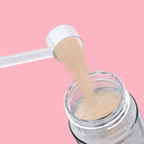 Qallo Hydration Strawberry tub: scoop of powder poured into a bottle
