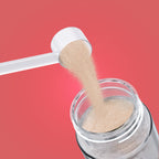Qallo Vitamins Grapefruit tub: scoop of powder poured into a bottle